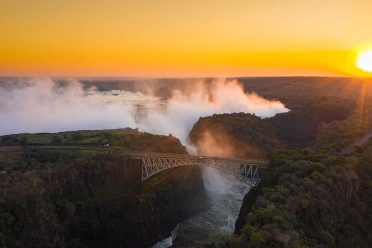 Guided Victoria Falls tour with mist rising from the gorge